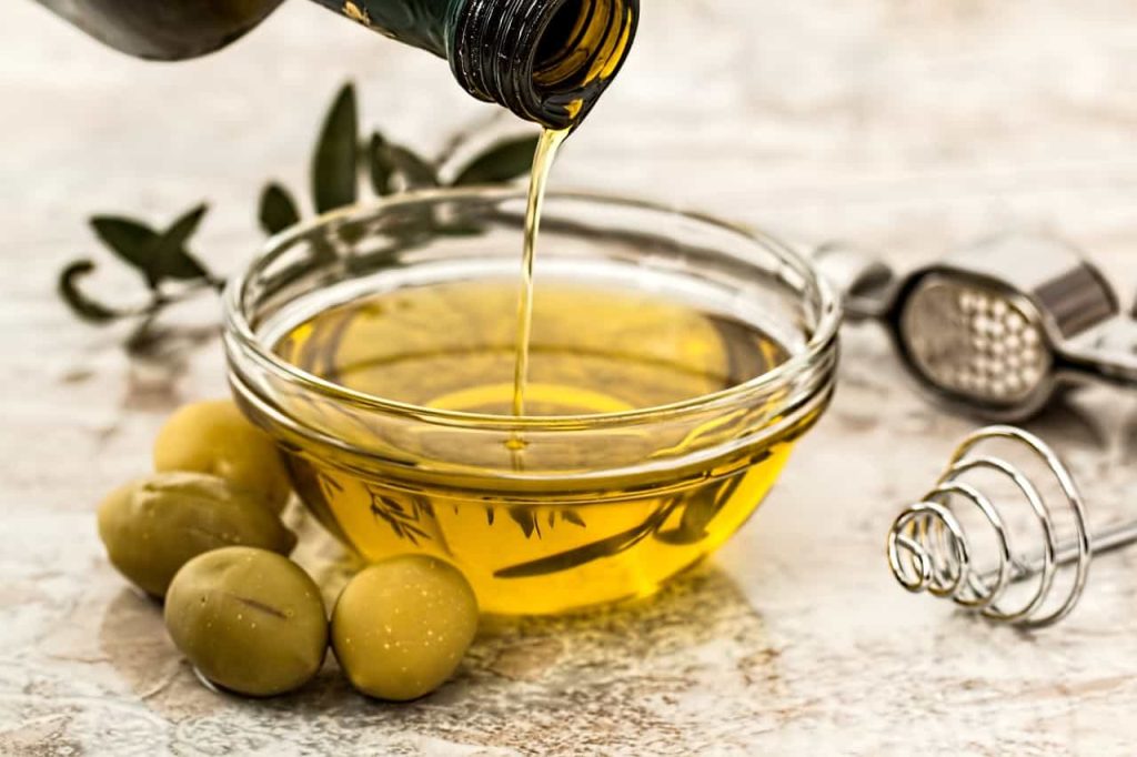pouring olive oil in a bowl