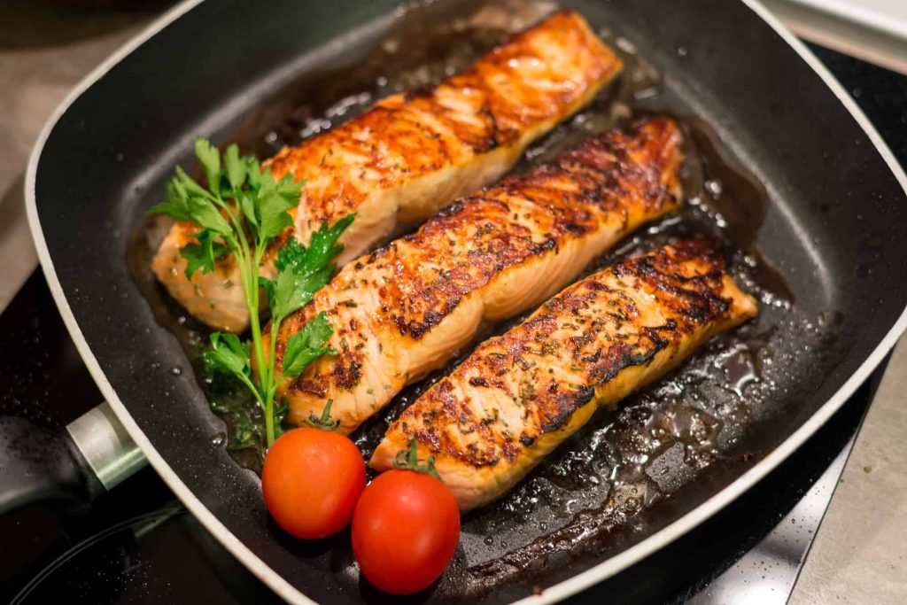 fresh salmon fillets grilled in a pan