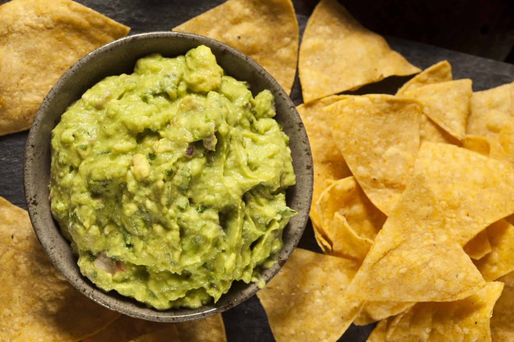 guacamole in a bowl with tortilla chips