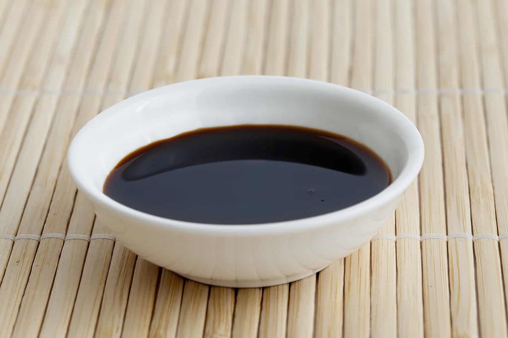 soy sauce in a small white bowl