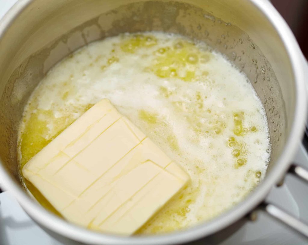boiling butter in a pot on a stove