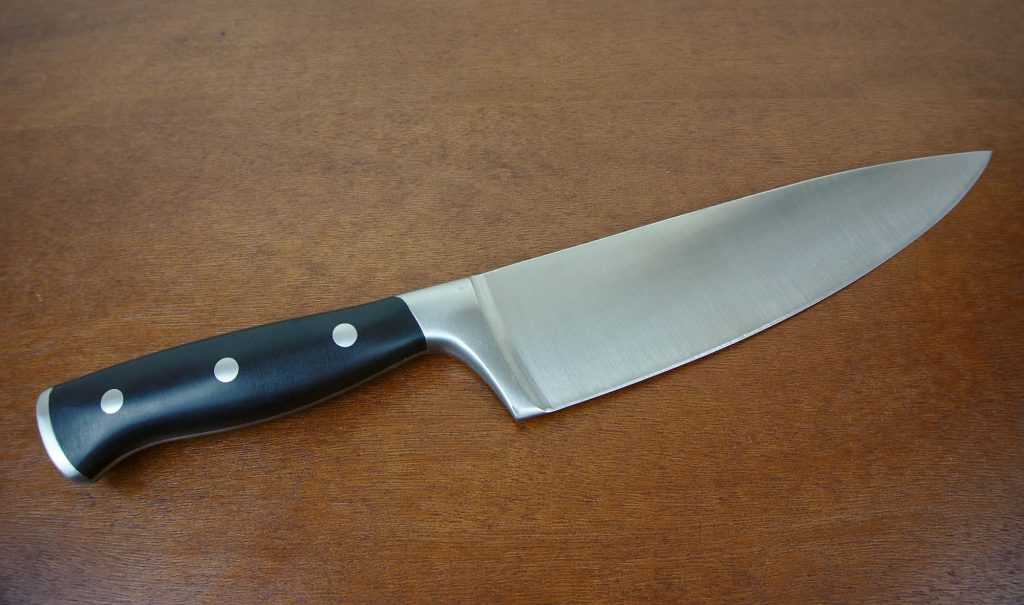 a sharpened chef's knife with black handle