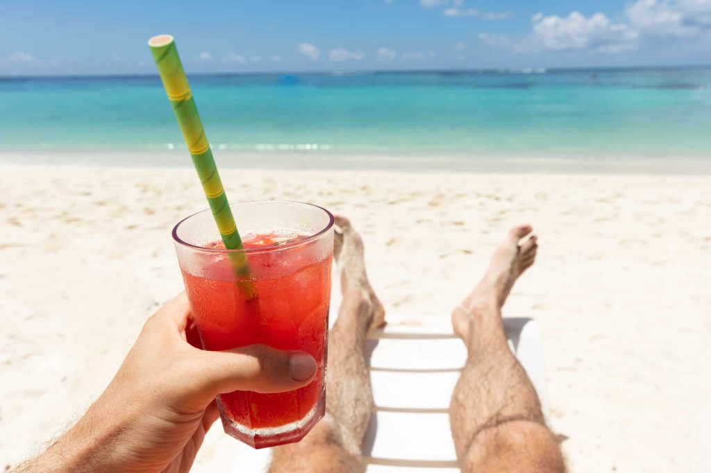 man holding a glass of Hawaiian punch