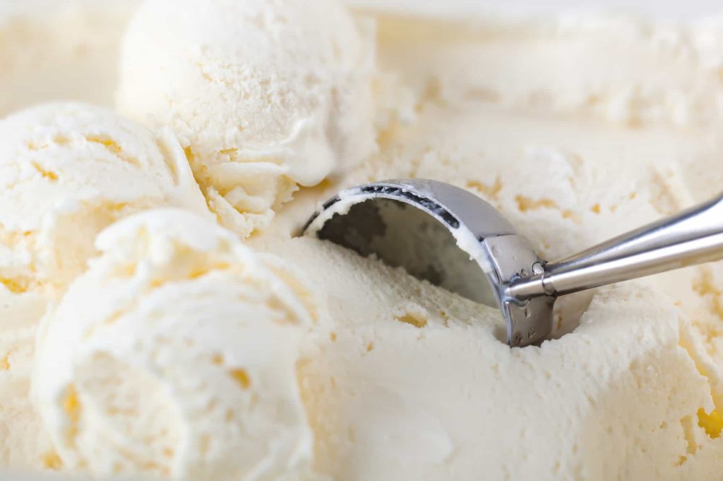 vanilla ice cream with spoon in the freezer