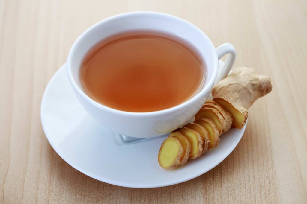 a cup of ginger tea in a white cup