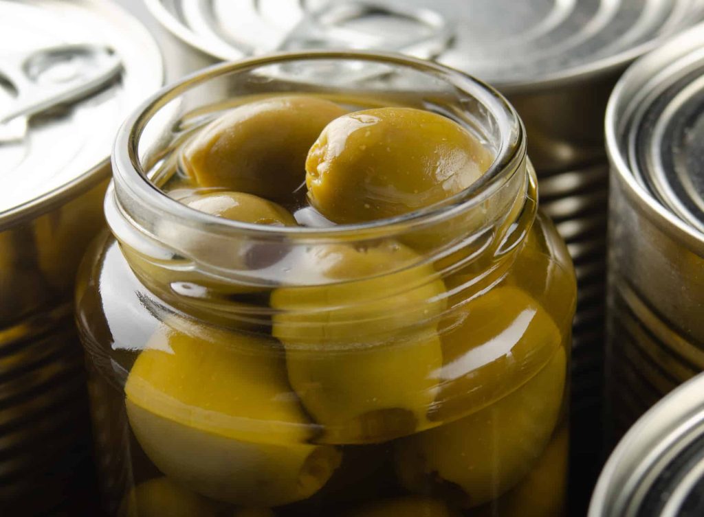 canned green olives in a mason jar