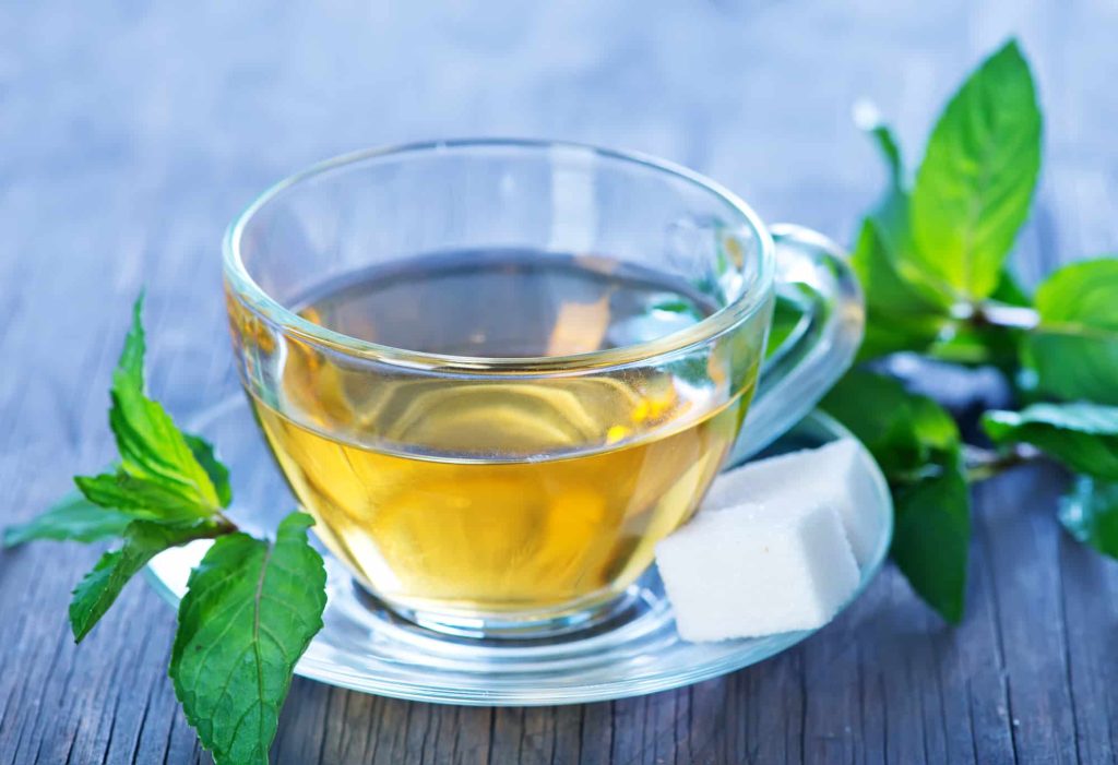 peppermint tea in a cup and on a table