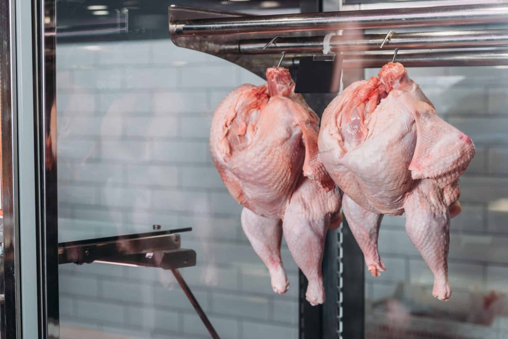 whole chicken with skin in grocery store