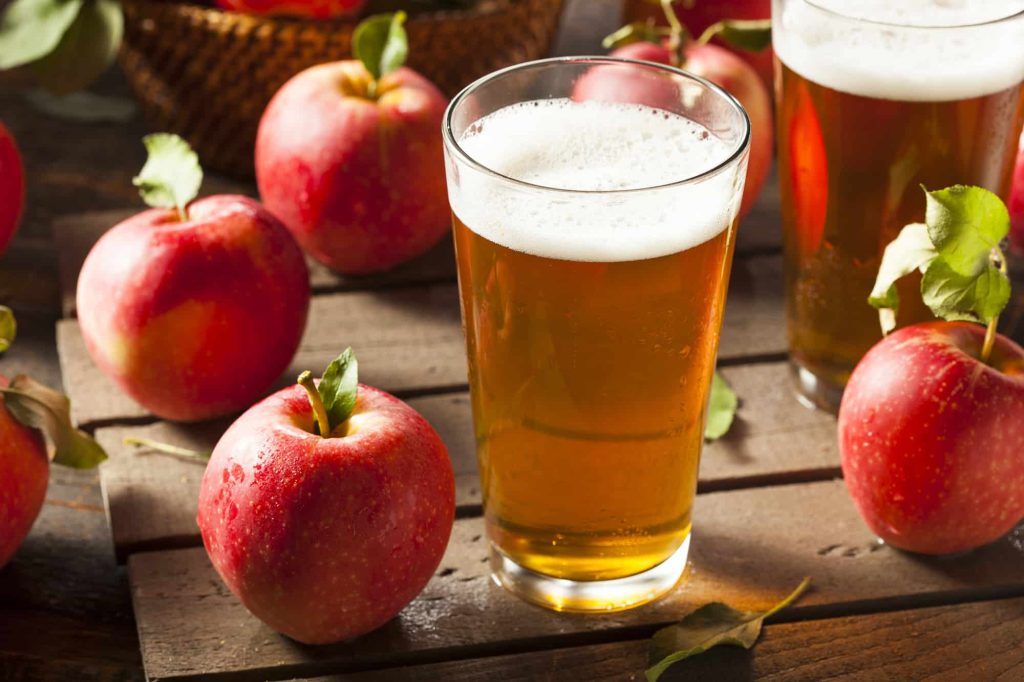 glasses of Hard Apple Cider on a wooden table
