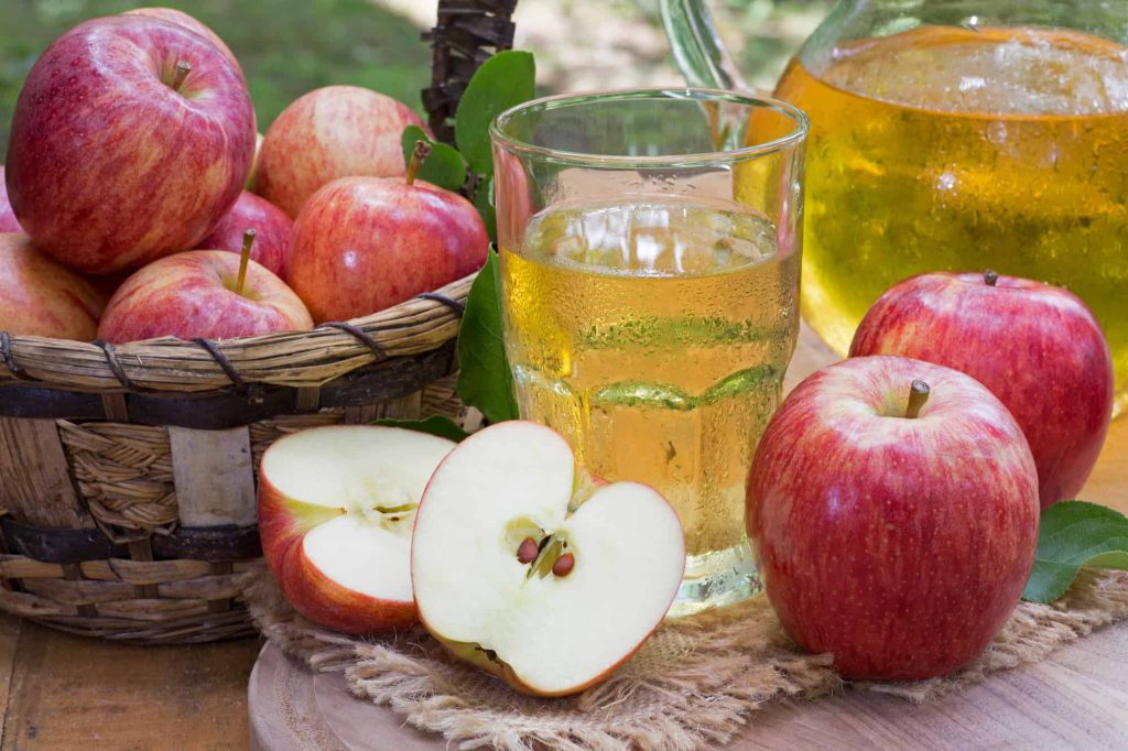 Glass of Apple Juice and Fresh Red Apples