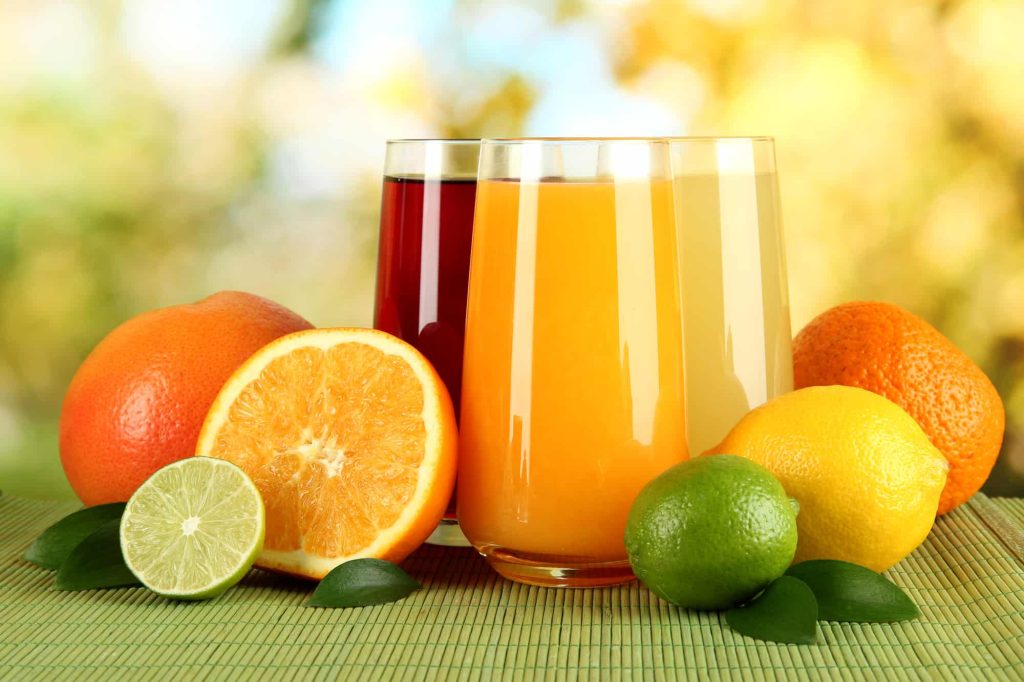 Glasses of fruit juice on table