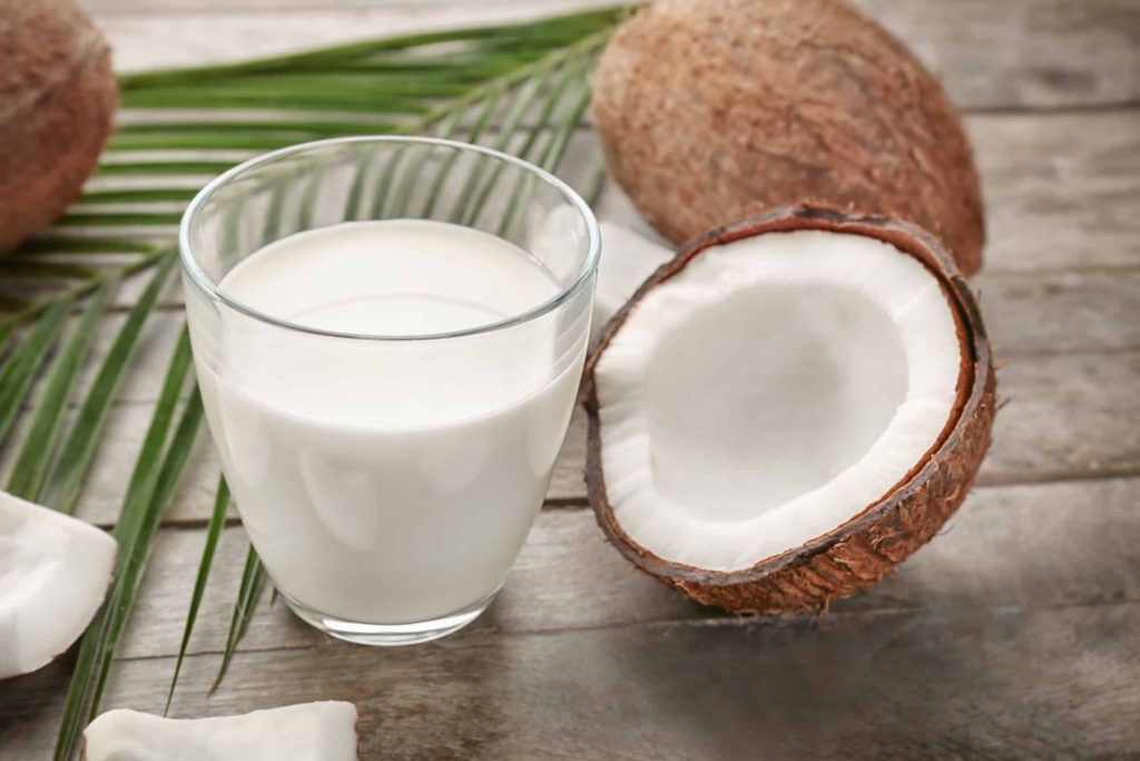 fresh coconut and coconut milk in a glass 