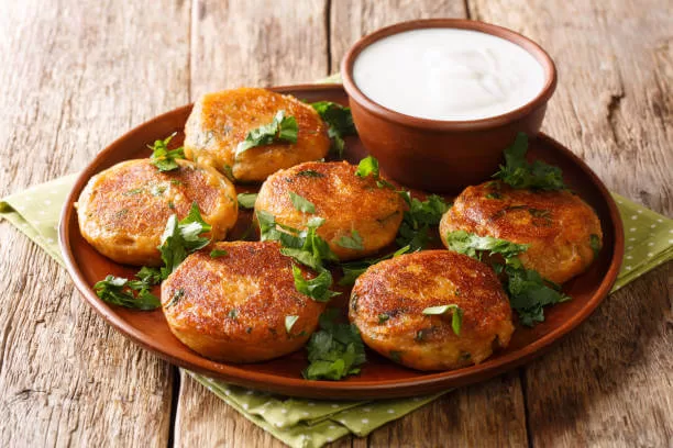 Aloo tikki, spiced potato patties shallow-fried crisp and served with chutney.