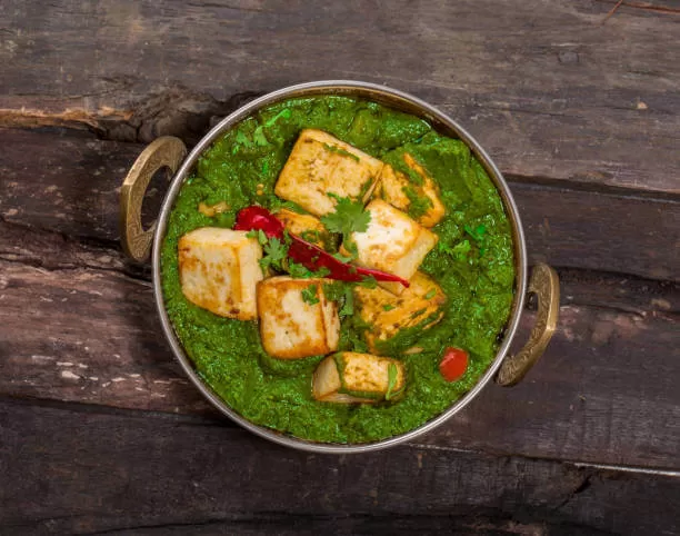 Palak paneer, cubes of paneer in a smooth creamy spinach sauce.