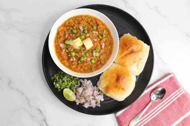 Pav bhaji, a spiced mashed vegetable curry served with soft buttered bread rolls.