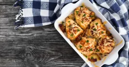 stuffed chicken breast with ham, cheese, tomatoes and Provencal herbs, baked in a gratin dish, sprinkled with chopped parsley, Italian kitchen