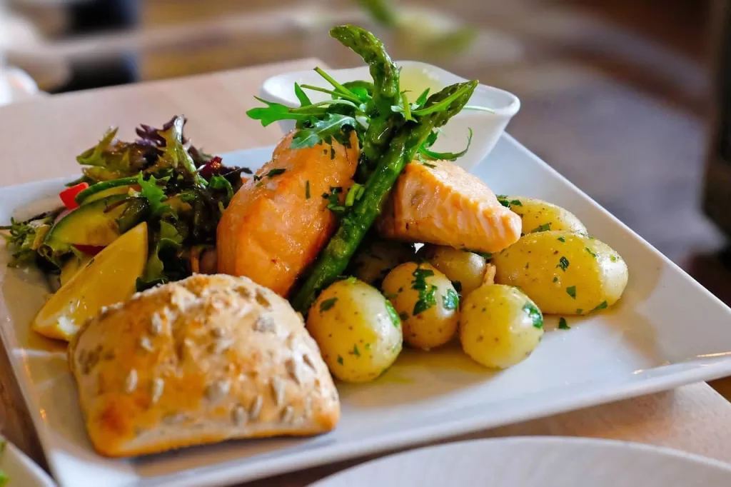 salmon baked with skin removed, served with salad and potatoes