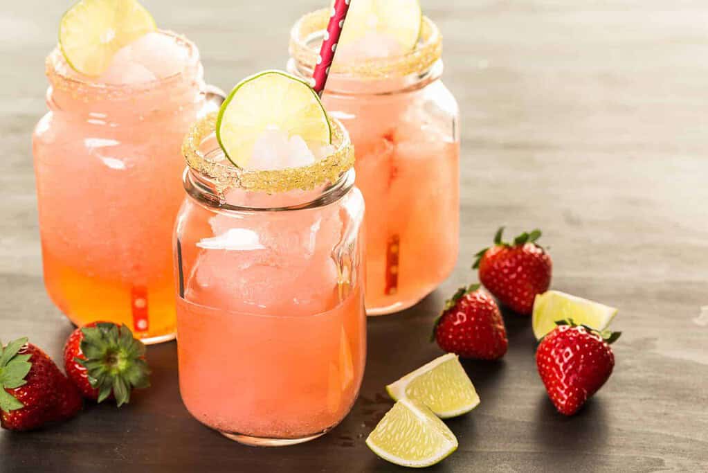 frozen strawberry margarita cocktail in drinking mason jar