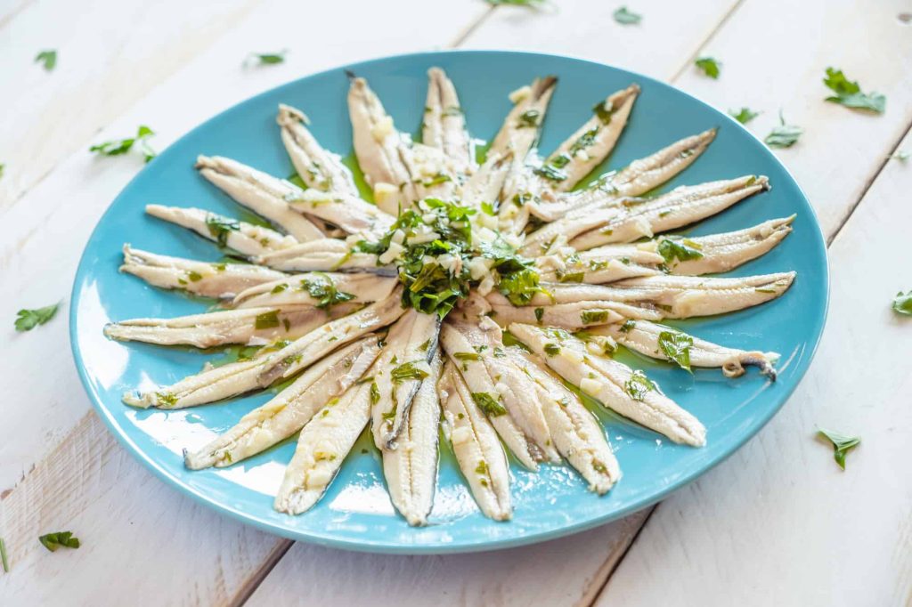 fresh anchovies marinated in vinegar with garlic and parsley