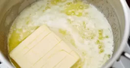 boiling butter in a pot on a stove