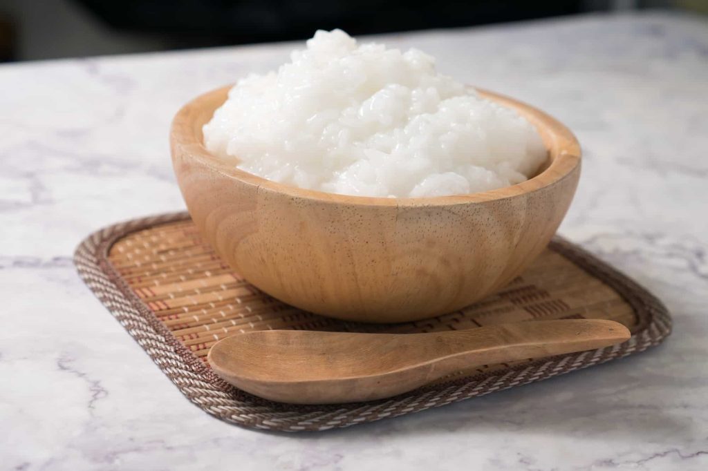 mushy rice in a wooden bowl