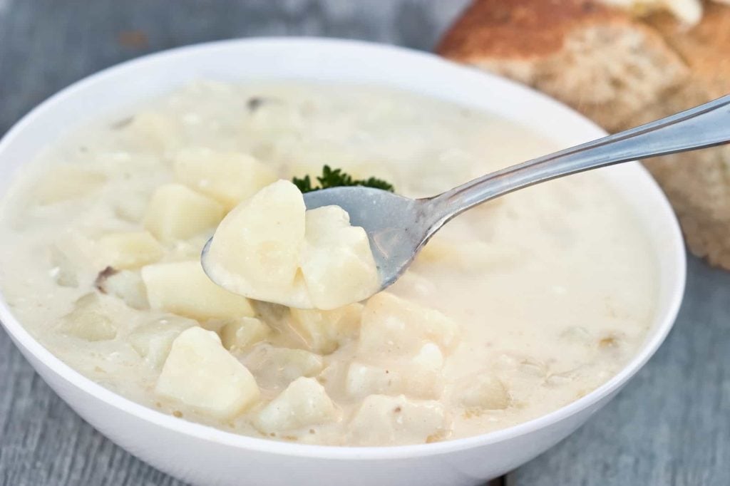 potato soup with spoon in a bowl