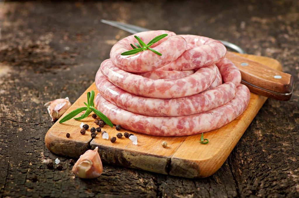 raw pork sausage on a cutting board