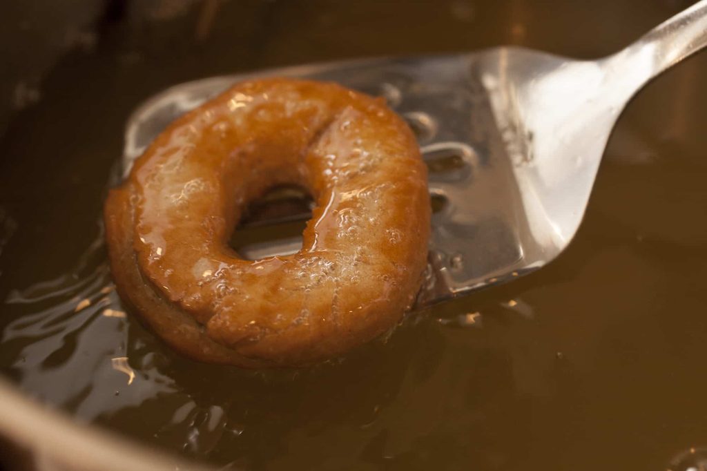 making donuts using frying ladle