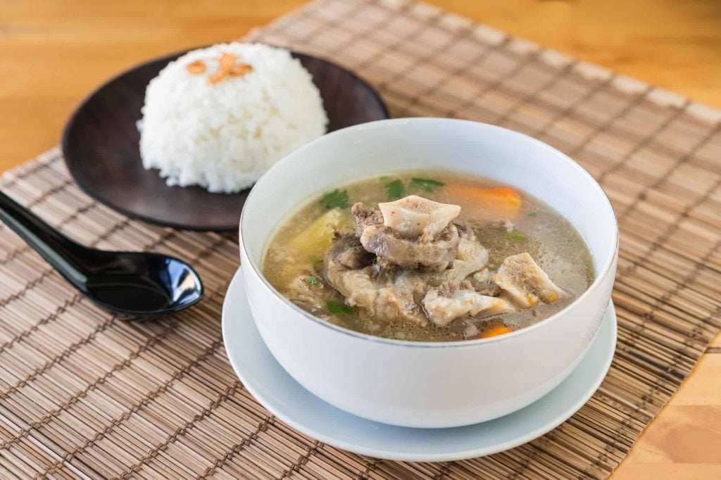 oxtail soup in a bowl and rice in a plate