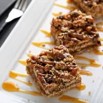 pecan pie bars on a white rectangular plate