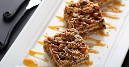 pecan pie bars on a white rectangular plate