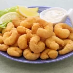 popcorn shrimp with tartar sauce on a plate