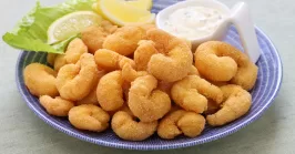 popcorn shrimp with tartar sauce on a plate