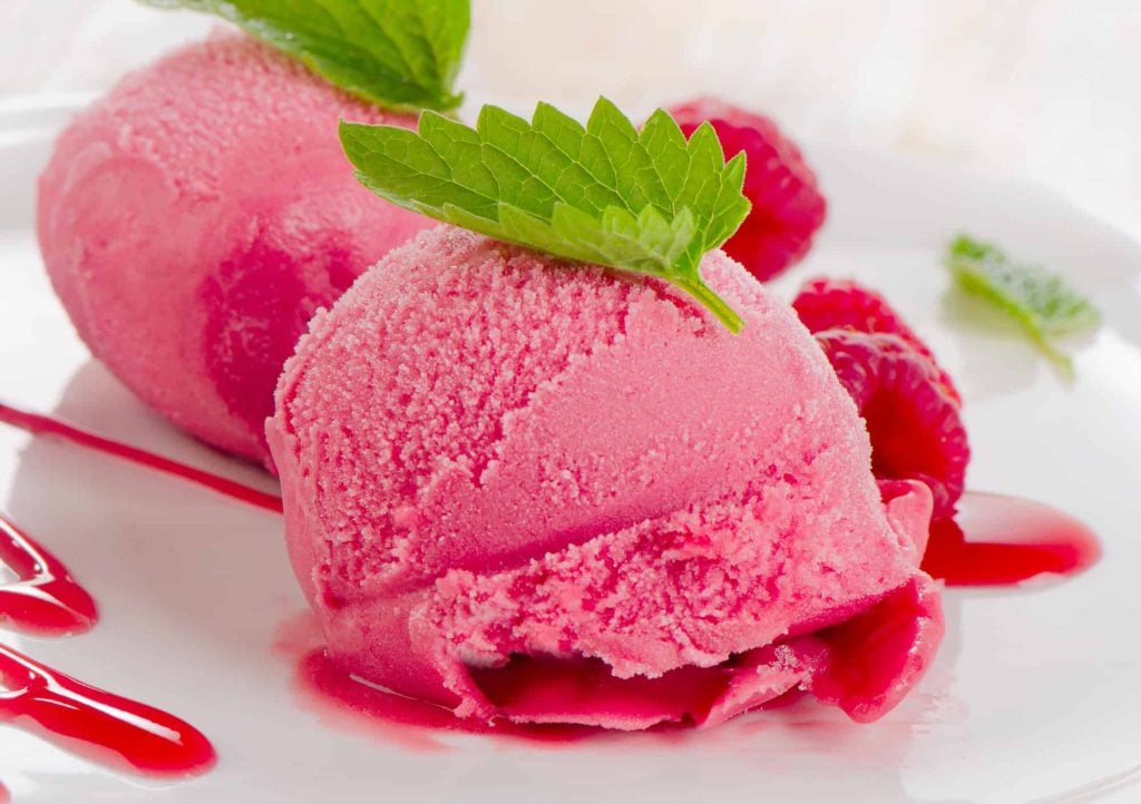 Raspberry sorbet ice cream with fresh mint