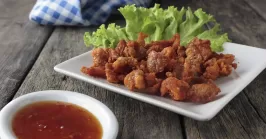 fried chicken skin and sauce on a table