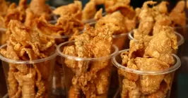 freshly deep fried chicken skin on display at a store