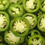 sliced green jalapenos with white seeds