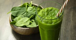 spinach smoothies in glass is on the table