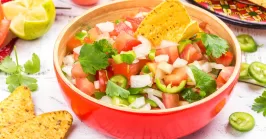 a bowl of Mexican pico de gallo with jalapenos and other ingredients