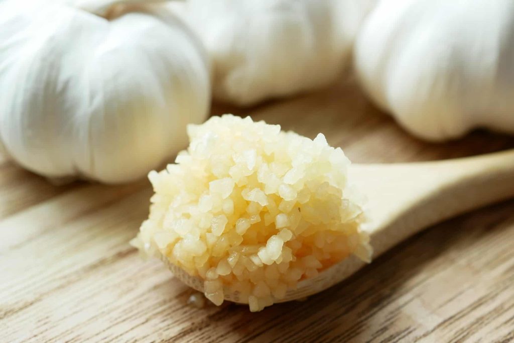  minced garlic on a wooden spoon