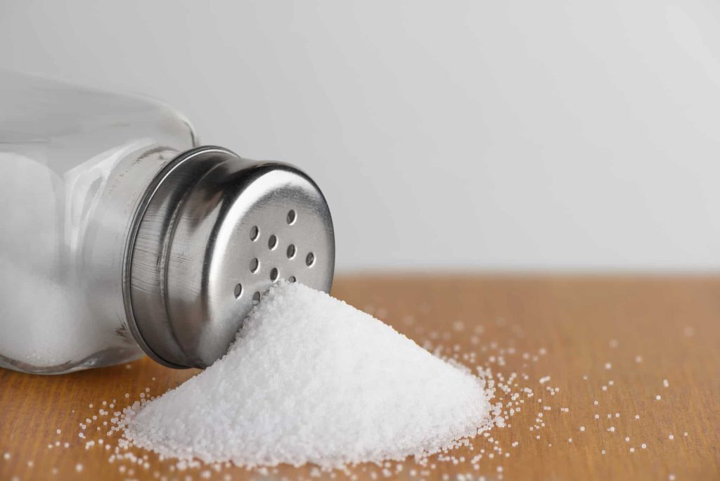 Salt shaker on wooden table