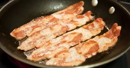 turkey bacon in a frying pan