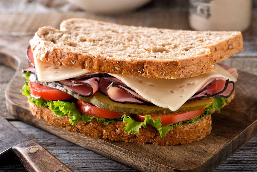 turkey sanwich on a rustic wood table.