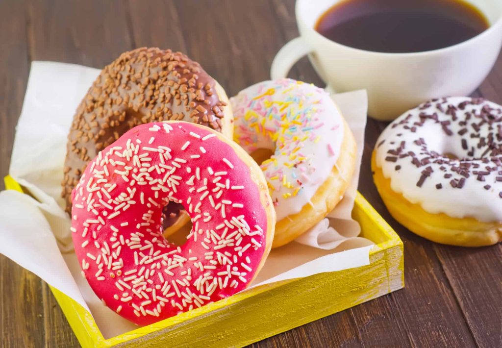 doughnuts and a cup of coffee on a table