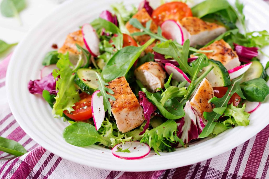 Nando's grilled chicken salad on a white plate