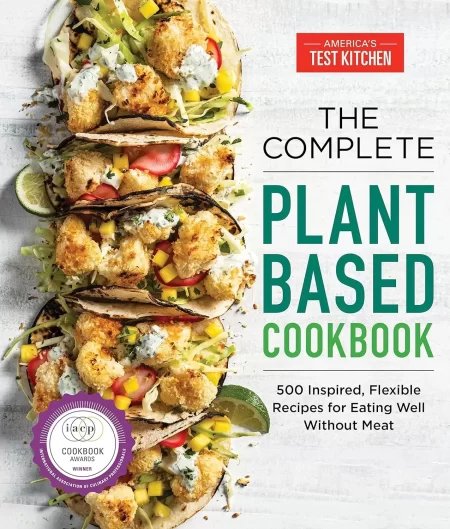 Cover of "The Complete Plant-Based Cookbook: 500 Inspired, Flexible Recipes for Eating Well Without Meat," part of The Complete ATK Cookbook Series by America's Test Kitchen. The cover showcases adaptable recipes such as vegetable tacos with sauce against a white background and features an award badge recognizing the book's excellence in cookbooks.