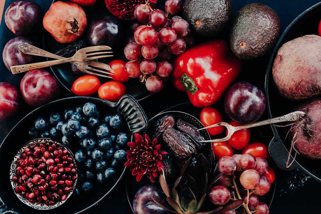 A colorful assortment of fruits and vegetables beautifully arranged in bowls, showcasing nature's bounty.