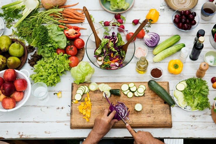 A colorful table filled with various fruits and vegetables, showcasing a vibrant selection for a healthy vegan diet. Perfect for managing eczema with nutritious options.