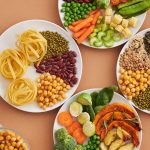 A colorful assortment of various foods beautifully arranged on plates, showcasing a delightful culinary spread.