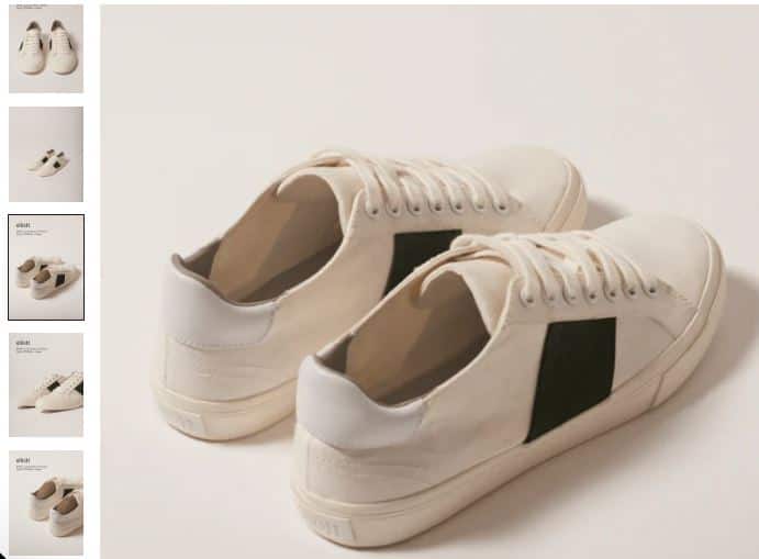 A pair of white sneakers featuring black and white stripes, made from climate-positive recycled canvas by elliott.